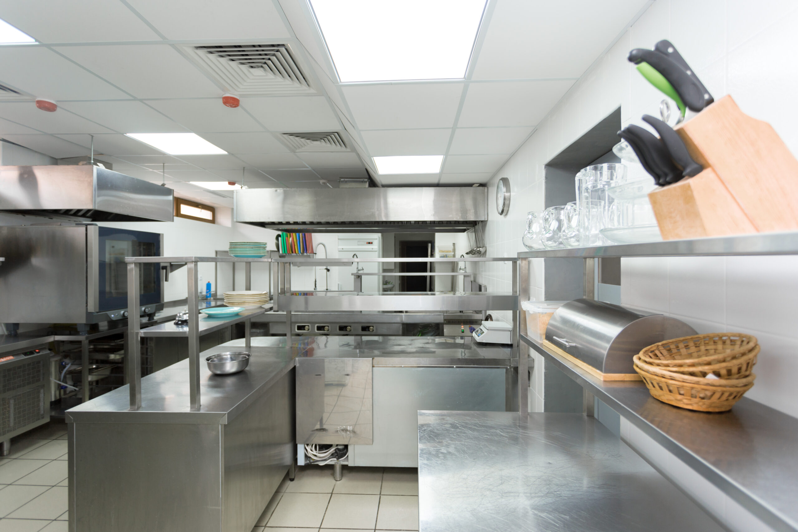 Modern kitchen setup with stainless steel equipment and organize